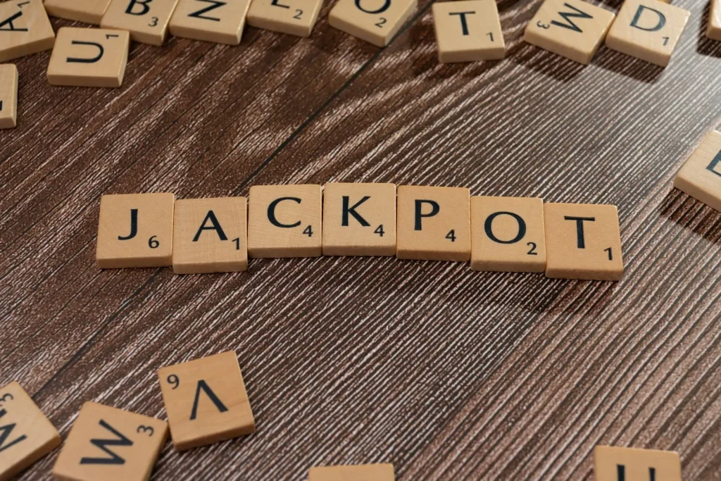 Powerball’s $562 Million Prize: Annuity, Cash Option and the Tax Reality Wooden letter tiles spelling the word JACKPOT on a textured wooden surface